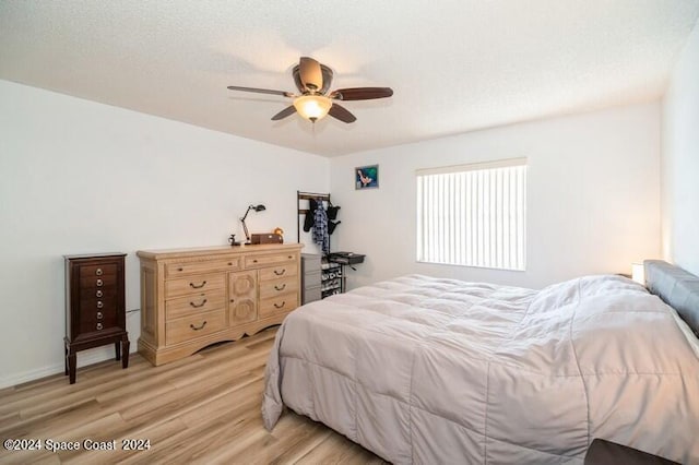 bedroom with ceiling fan and light hardwood / wood-style flooring