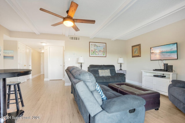 living room with light wood-type flooring, beam ceiling, and ceiling fan