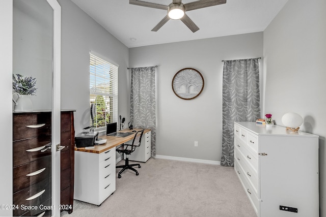 carpeted office space with ceiling fan