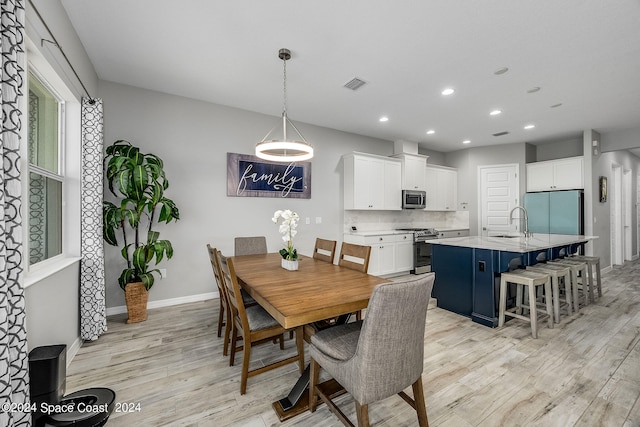 dining room featuring light hardwood / wood-style floors and sink