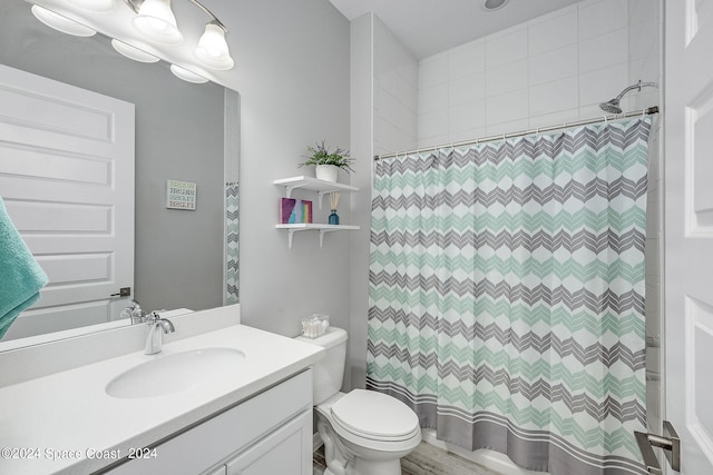 bathroom featuring wood-type flooring, vanity, toilet, and a shower with curtain