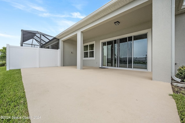 view of patio / terrace featuring glass enclosure