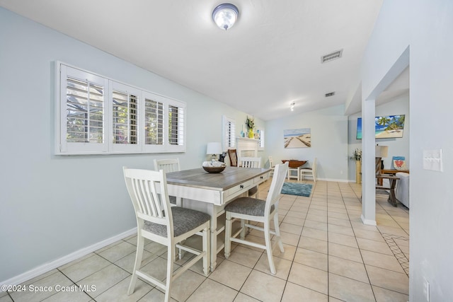 tiled dining space with lofted ceiling