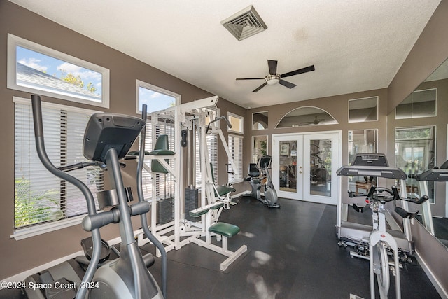 exercise room with ceiling fan, french doors, and a textured ceiling