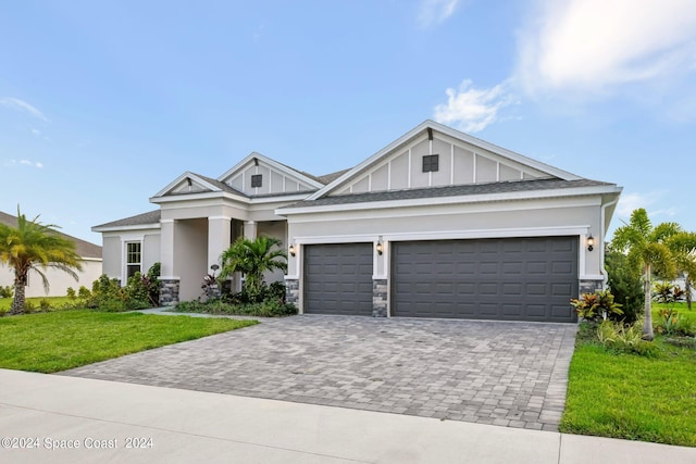 view of front of home with a garage and a front lawn