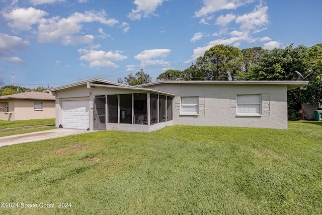 view of front of house with a sunroom, a front yard, and a garage