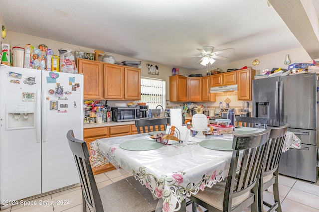 kitchen featuring ceiling fan, stainless steel appliances, and light tile patterned floors