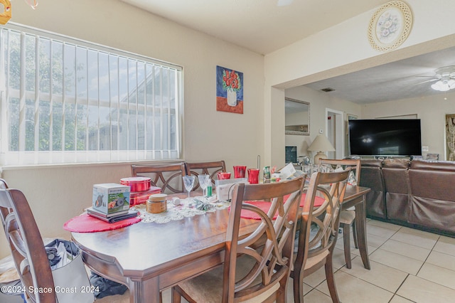 dining space with light tile patterned flooring and ceiling fan