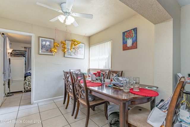 tiled dining space with ceiling fan