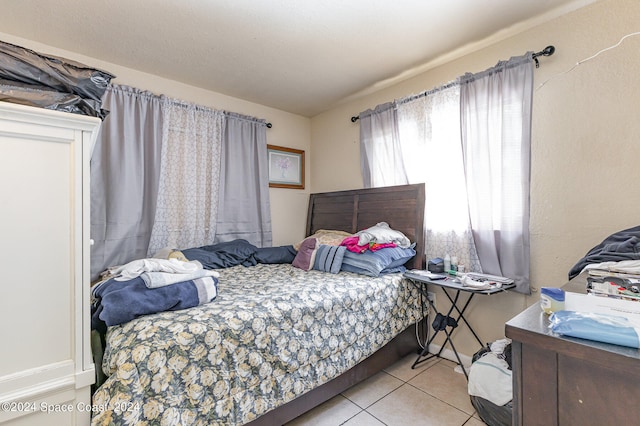 bedroom with light tile patterned floors