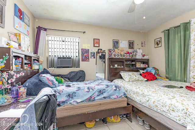 tiled bedroom with cooling unit and ceiling fan