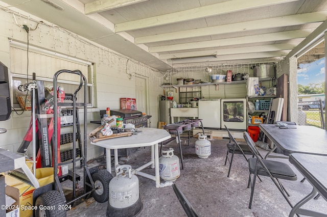 garage featuring white refrigerator and gas water heater