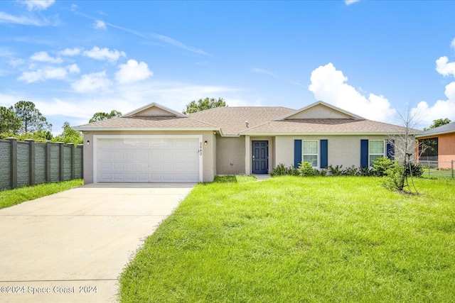 ranch-style home with a garage and a front yard