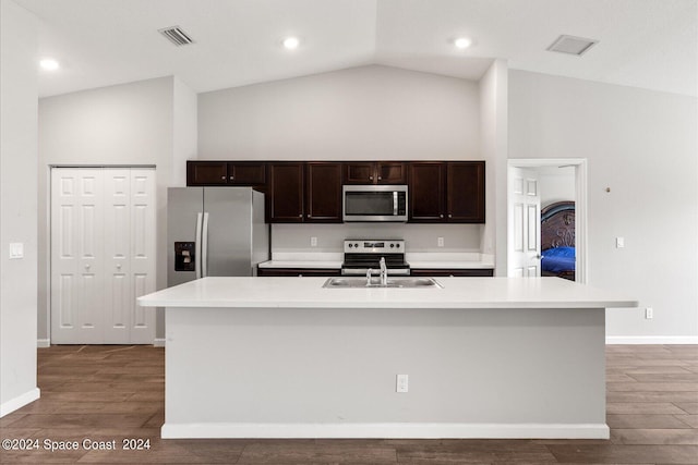 kitchen featuring a kitchen island with sink, stainless steel appliances, sink, and hardwood / wood-style floors