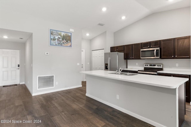 kitchen featuring vaulted ceiling, dark hardwood / wood-style flooring, stainless steel appliances, a center island with sink, and sink