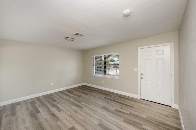 spare room with light hardwood / wood-style flooring