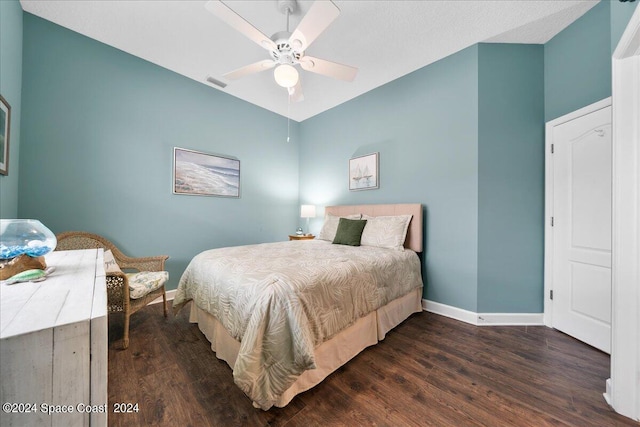 bedroom featuring ceiling fan and dark hardwood / wood-style floors