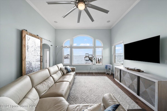 living room featuring dark hardwood / wood-style flooring, ornamental molding, and ceiling fan