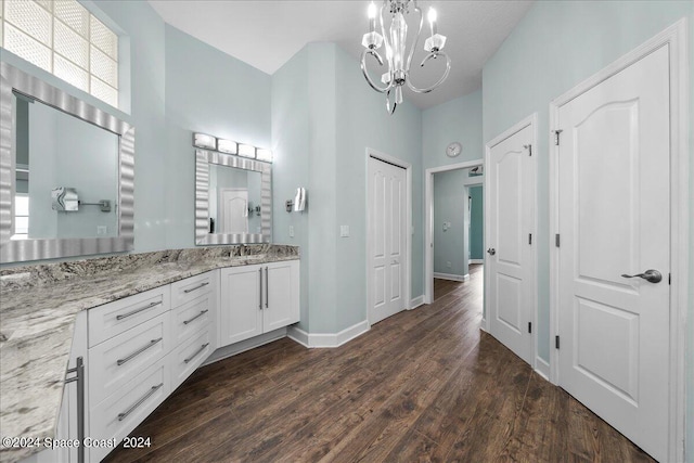 bathroom featuring vanity, hardwood / wood-style flooring, and a chandelier