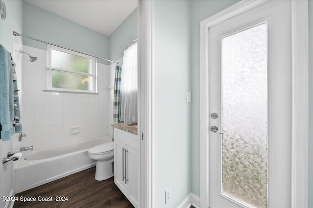 full bathroom featuring toilet, vanity, wood-type flooring, and shower / tub combo