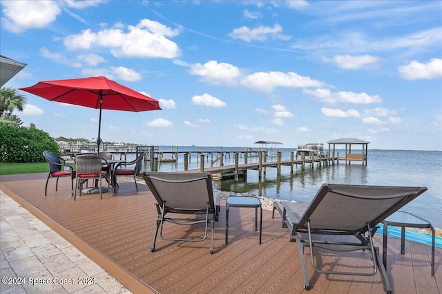 exterior space featuring a dock and a water view