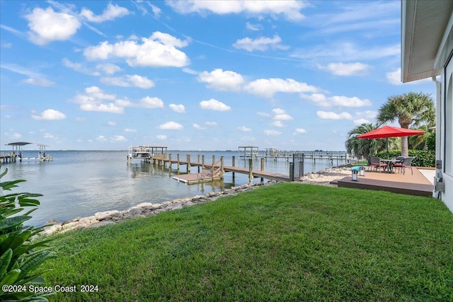 dock area featuring a water view and a yard