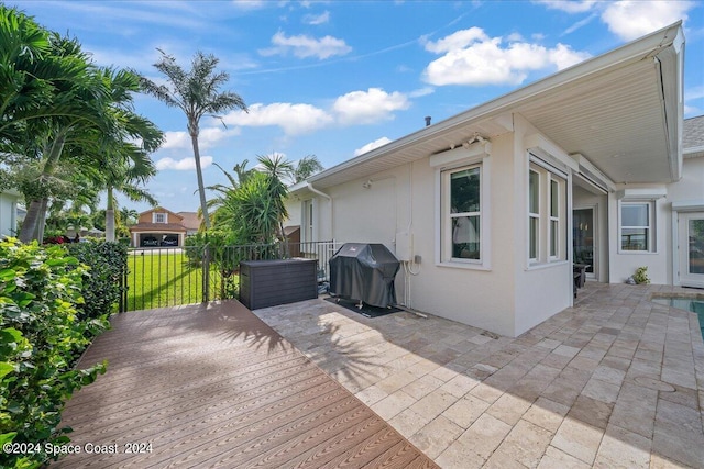 view of patio featuring area for grilling and a wooden deck