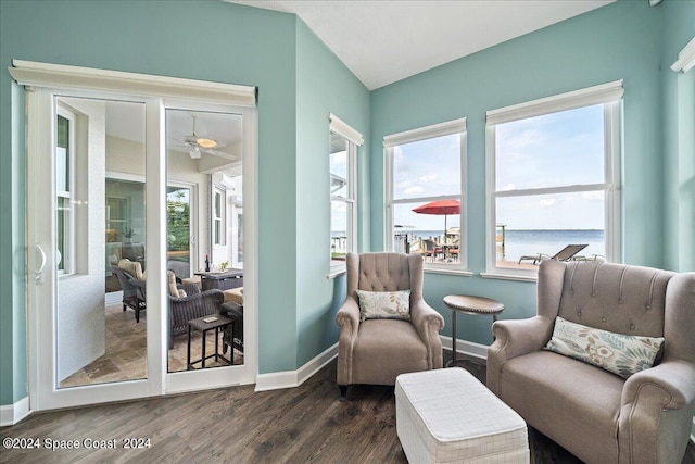 living area featuring a water view, ceiling fan, and dark hardwood / wood-style flooring