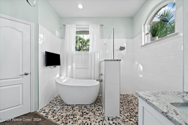 bathroom featuring vanity, hardwood / wood-style flooring, and separate shower and tub