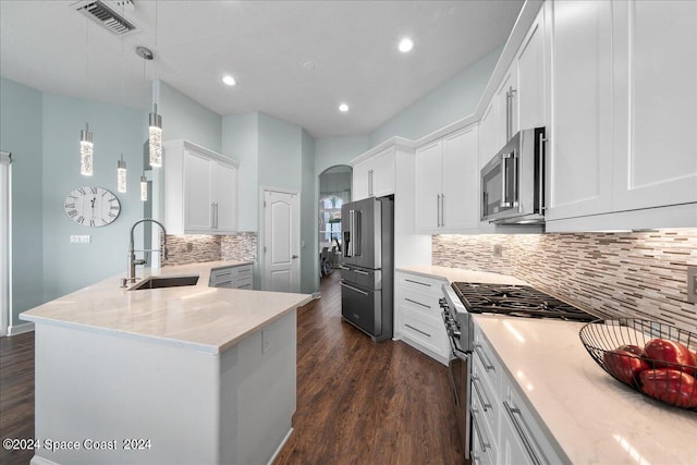 kitchen with dark wood-type flooring, hanging light fixtures, sink, premium appliances, and white cabinetry