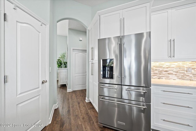 kitchen featuring high end fridge, white cabinets, backsplash, and dark hardwood / wood-style flooring