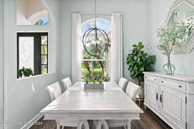 dining area with a chandelier and dark wood-type flooring