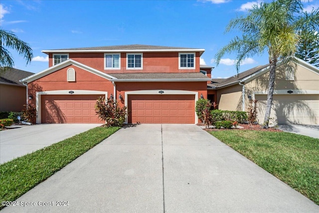 view of front property with a garage and a front lawn