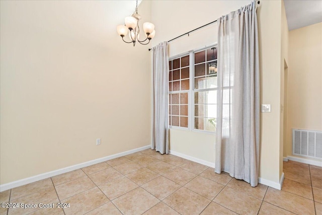 unfurnished dining area featuring a notable chandelier and light tile patterned floors