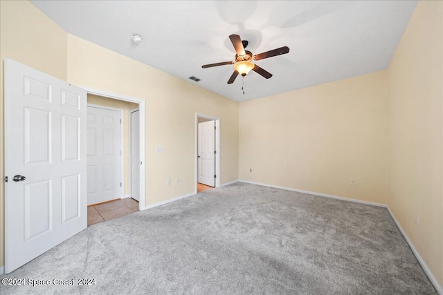 unfurnished bedroom featuring ceiling fan and light carpet