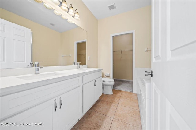 bathroom with tile patterned flooring, vanity, and toilet