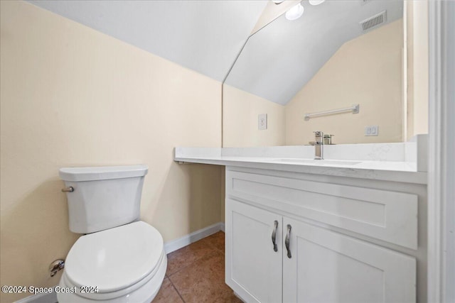 bathroom featuring vaulted ceiling, vanity, tile patterned flooring, and toilet