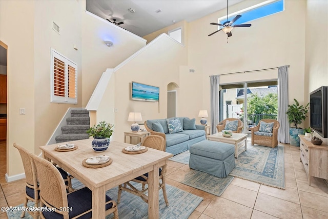 tiled living room featuring a towering ceiling and ceiling fan