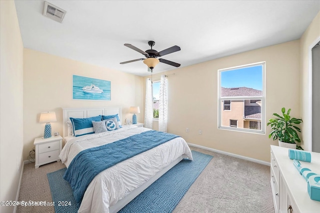 bedroom with light carpet and ceiling fan