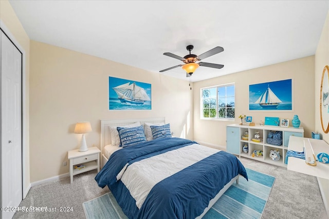 bedroom with light carpet, a closet, and ceiling fan