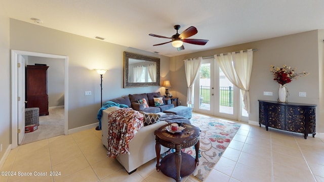 tiled living room featuring ceiling fan and french doors