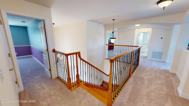 hallway featuring light colored carpet