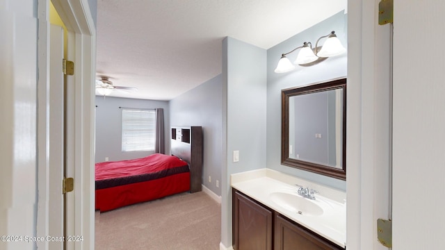 bathroom featuring ceiling fan and vanity