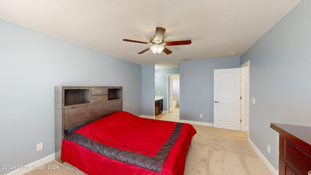 carpeted bedroom featuring ceiling fan and ensuite bathroom