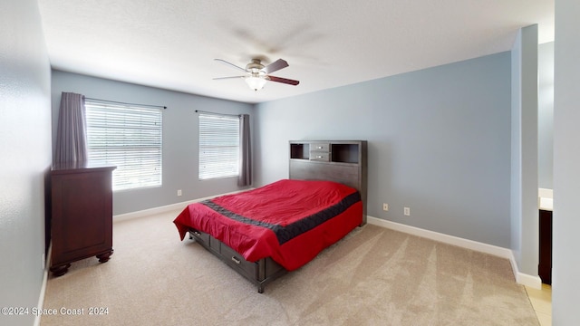 bedroom featuring light carpet and ceiling fan