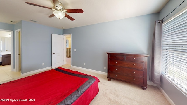 carpeted bedroom with connected bathroom and ceiling fan