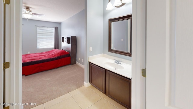 bathroom featuring ceiling fan, vanity, and tile patterned flooring