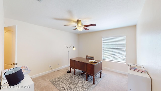 office area featuring light carpet and ceiling fan