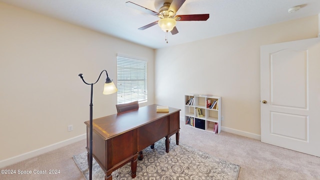 carpeted office space featuring ceiling fan