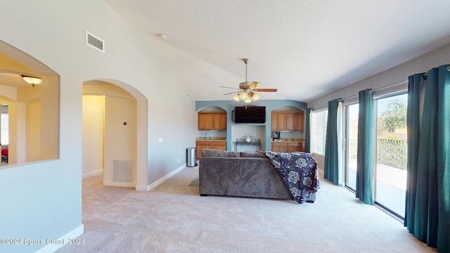 carpeted living room featuring ceiling fan and high vaulted ceiling